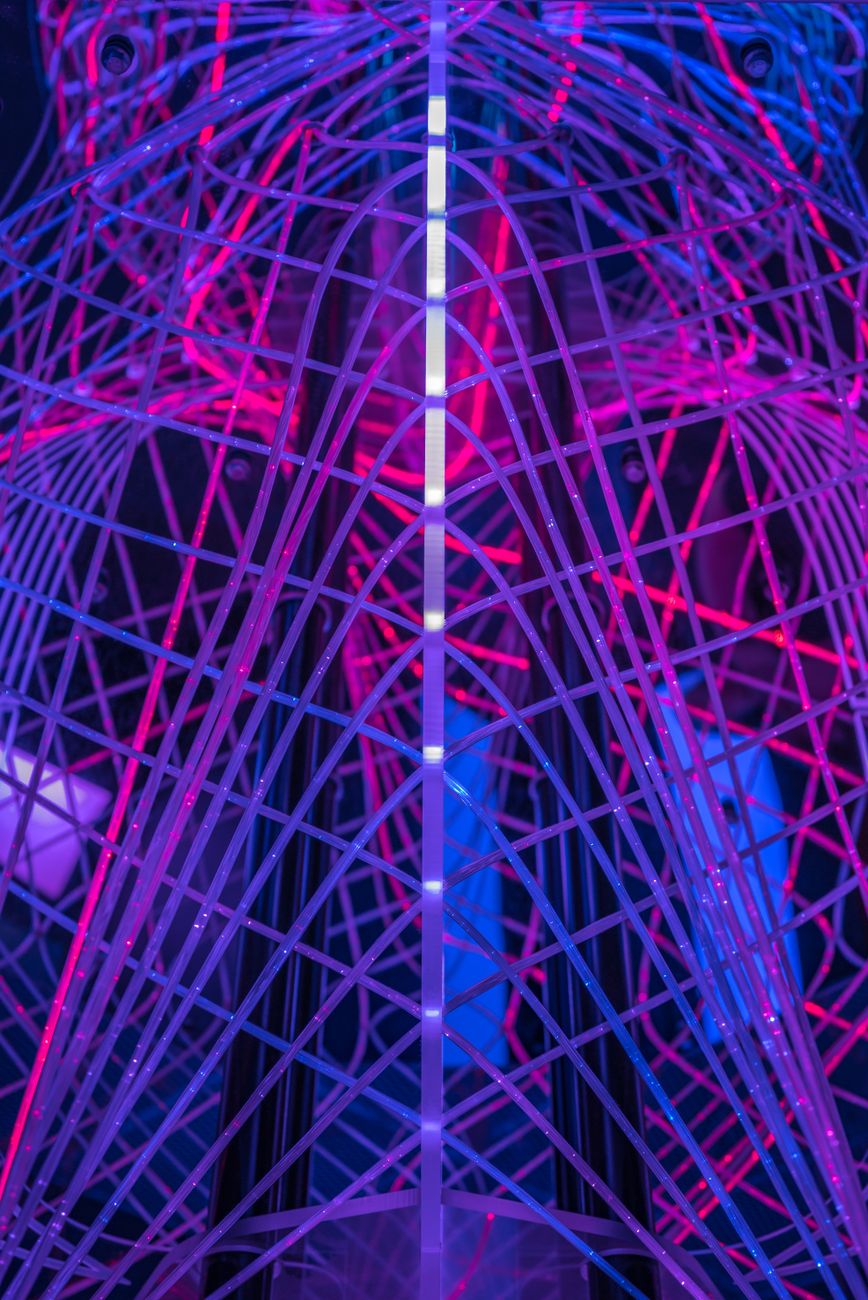 Neon-lit steel lattice glowing pink and blue