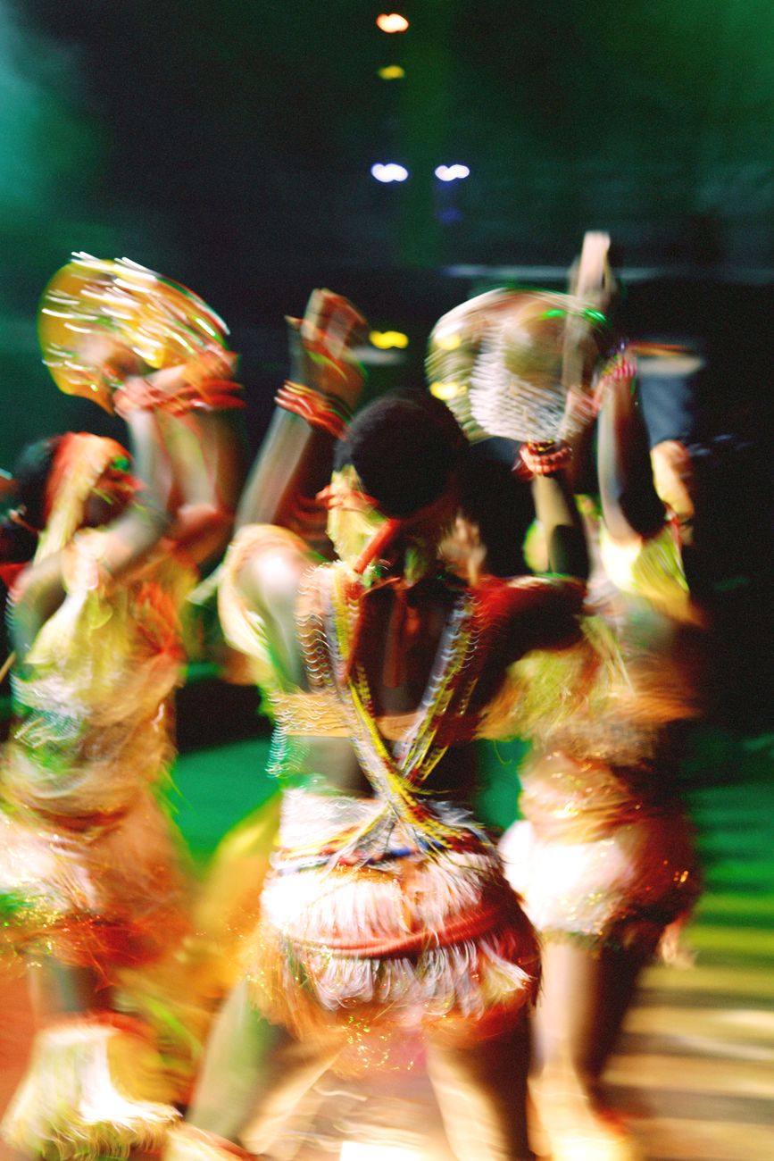 Dancers in motion blur under stage lights