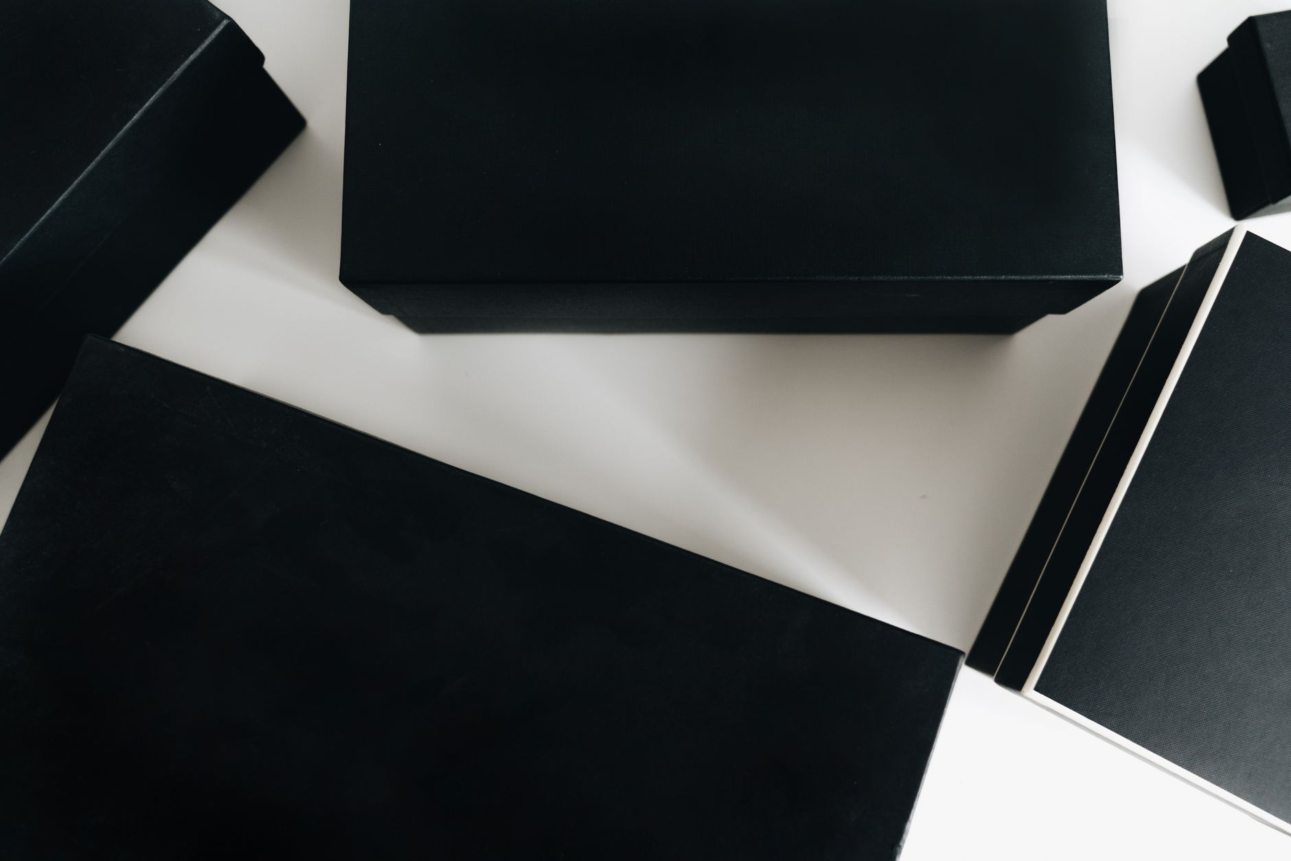Black boxes and lids on a white table
