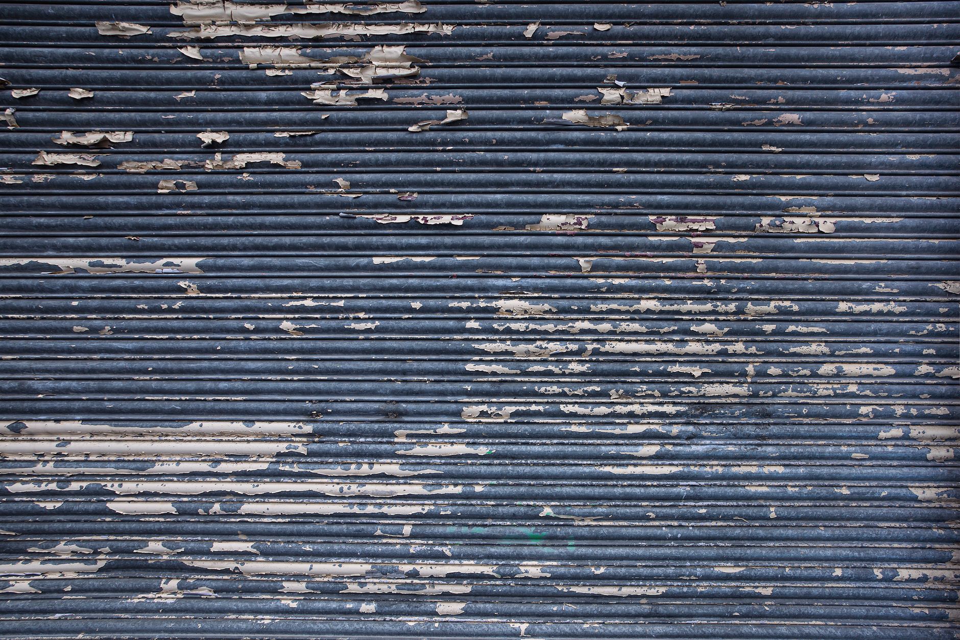 Before: a peeling metal shop shutter
