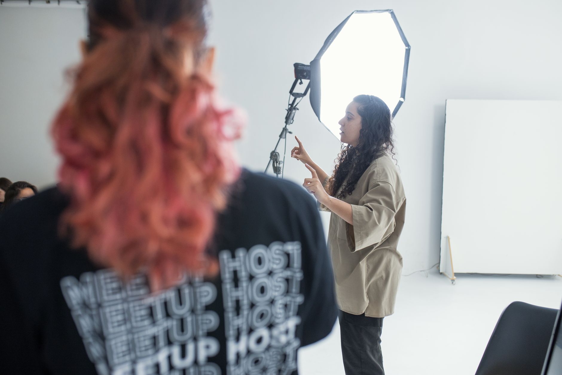 Photographer adjusting a studio light during a shoot