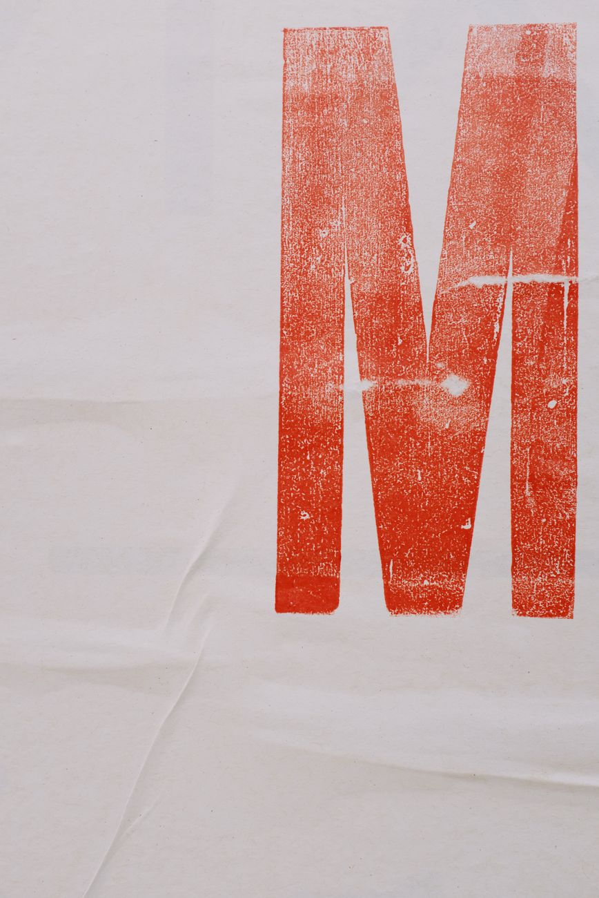 Letterpress M printed in red on paper