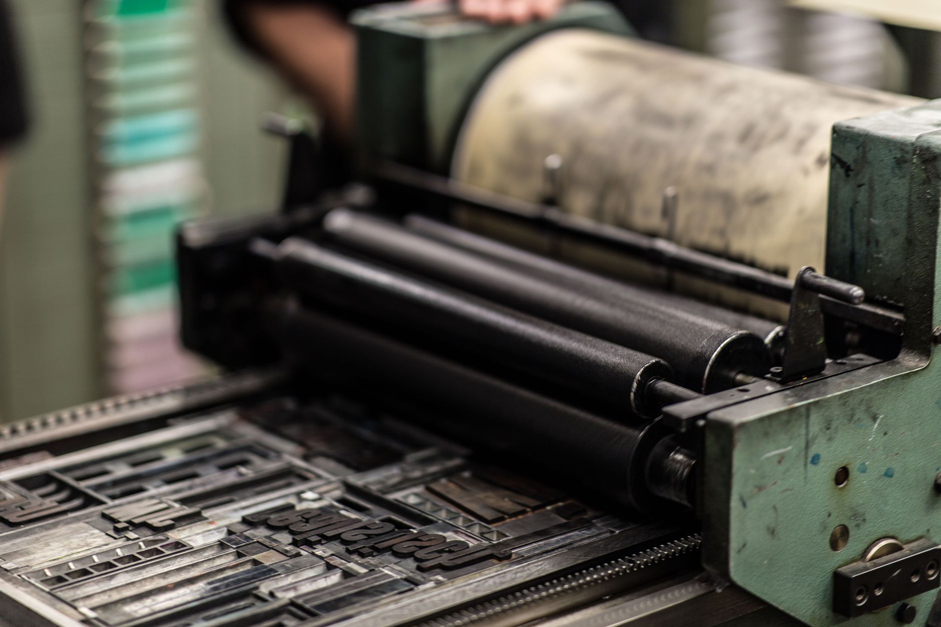 Close-up of the inked rollers of a letterpress printing machine