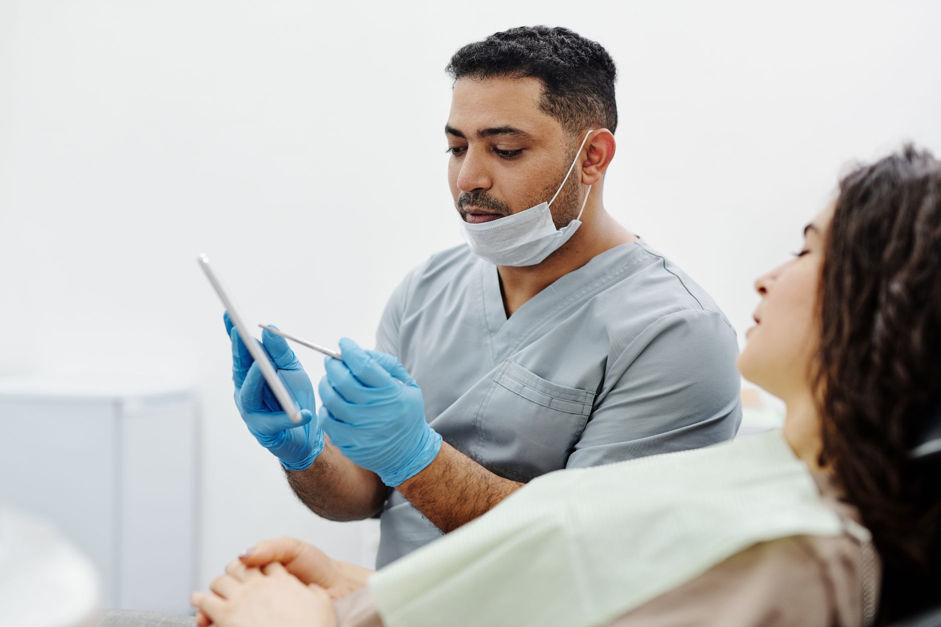 Dentist showing a patient a tablet