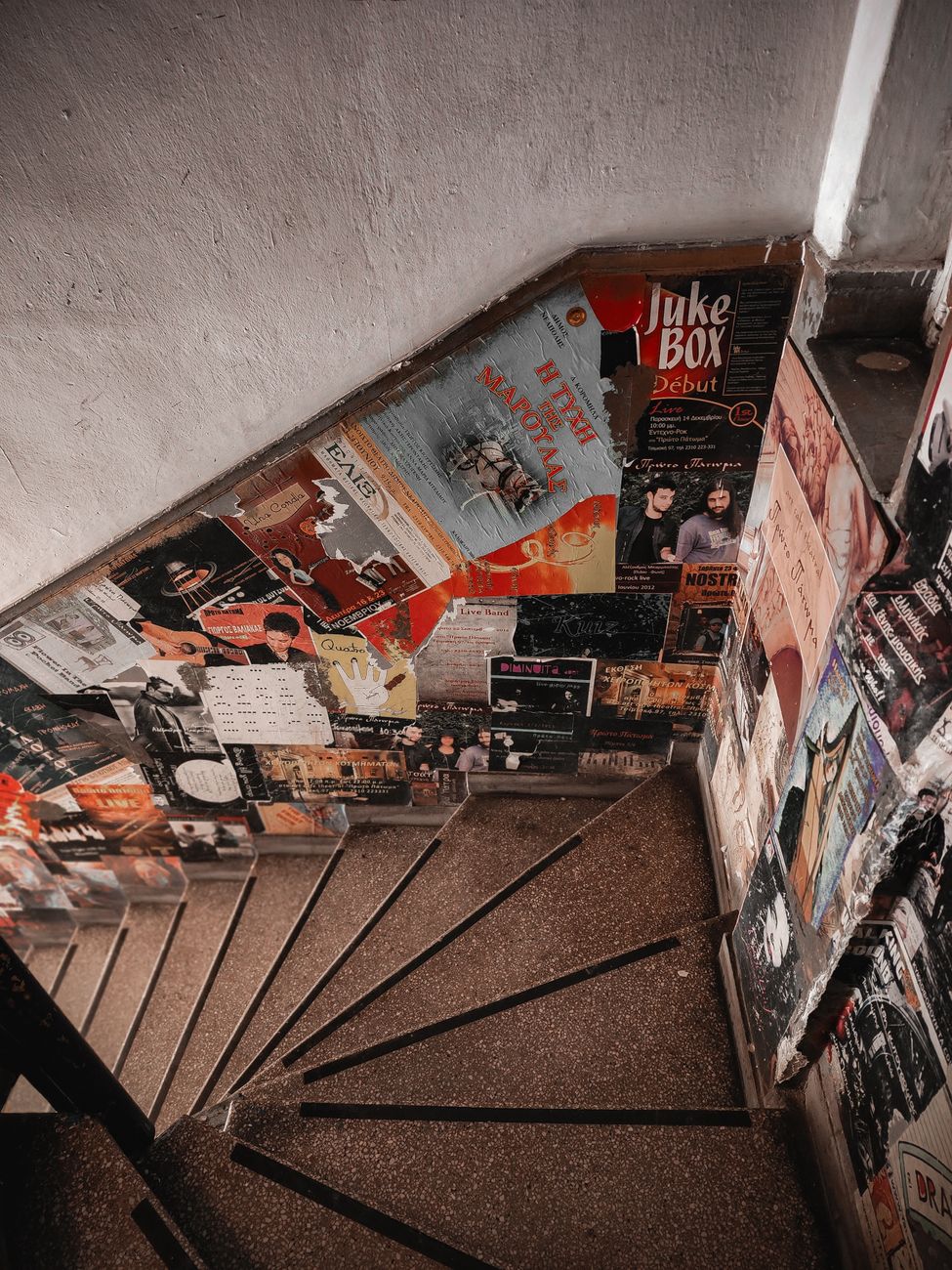 Stairwell walls covered in vintage posters